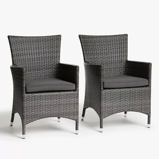 Two rattan garden dining chairs