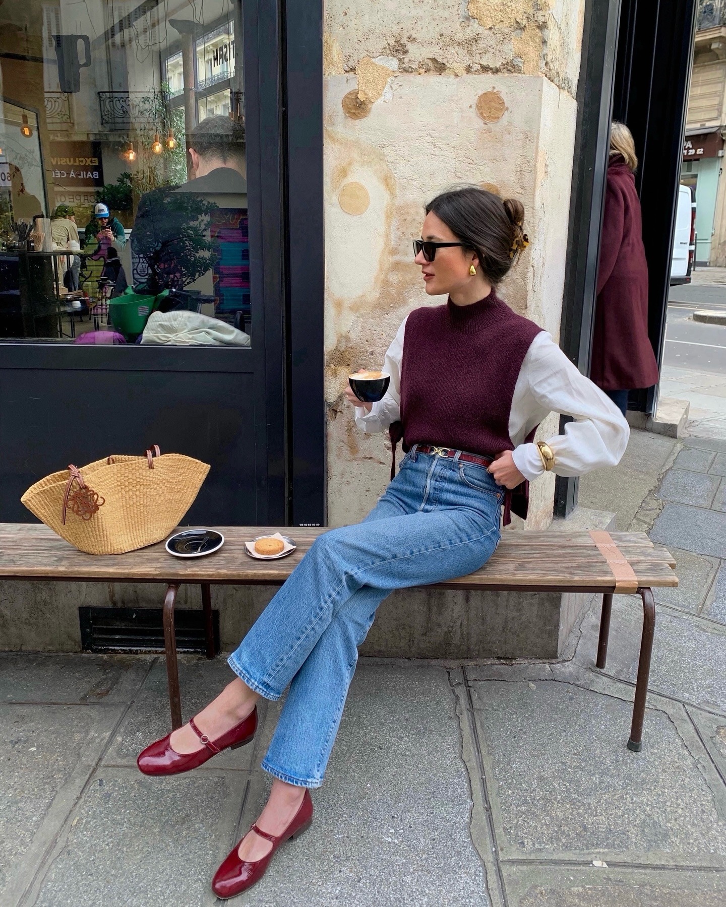 Influencer Julie wears blue jeans and a sweater with red ballet flats.