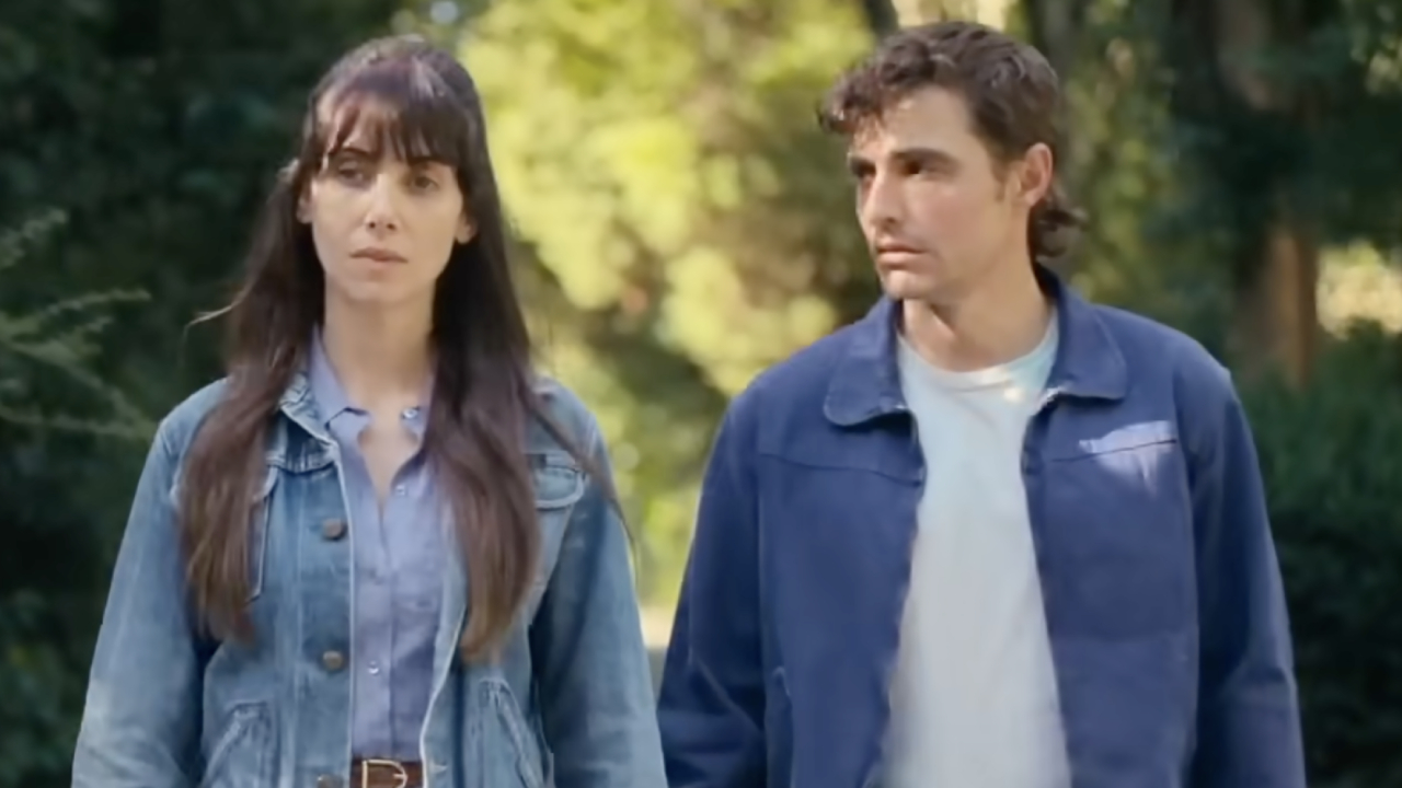 A distant Alison Brie and Dave Franco holding hands in Together.
