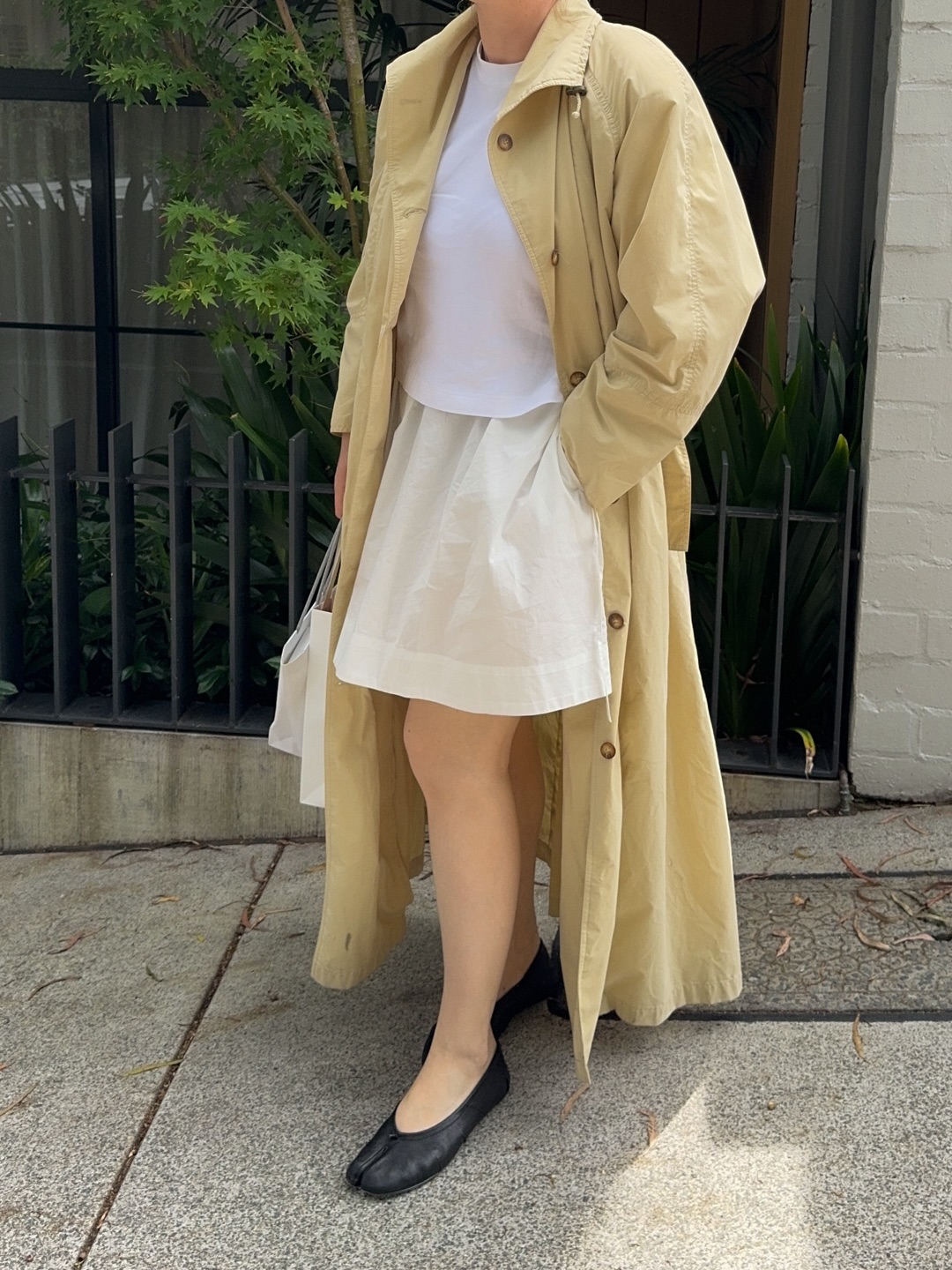 Ali Whiitle wears Trench Coat + Mini Skirt + Ballet Pumps
