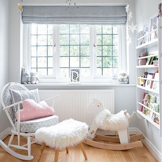 Girls nursery with grey blind and rocking chair
