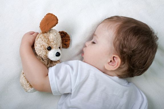 A child sleeping peacefully in a crib.