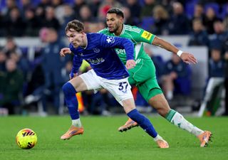 Newcastle United's Joelinton battles for the ball with Everton's James Garner