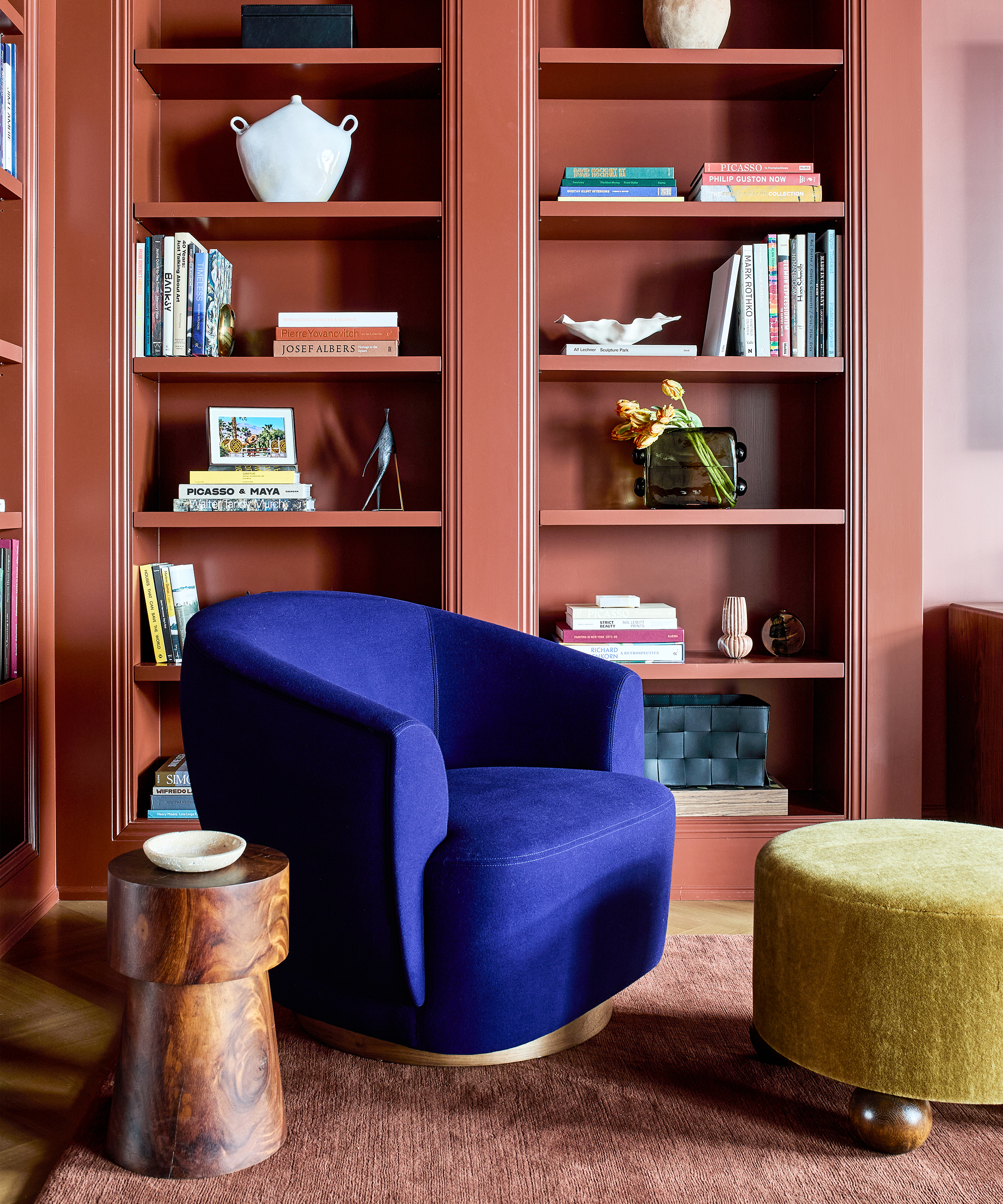 pink reading corner with bright blue armchair