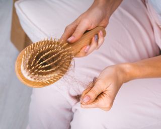 Pulling hair out of wooden hairbrush
