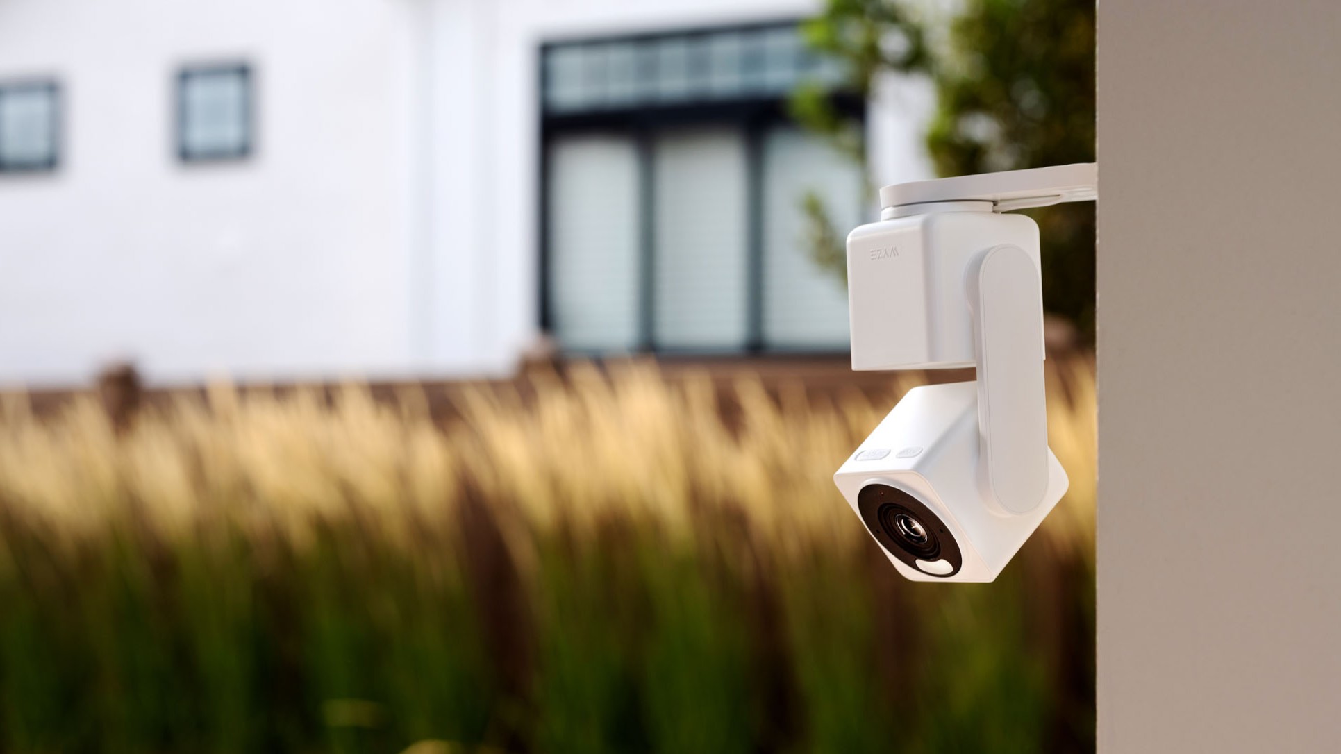 Wyze Cam Pan v4 attached to the exterior of a house with a yard in the background