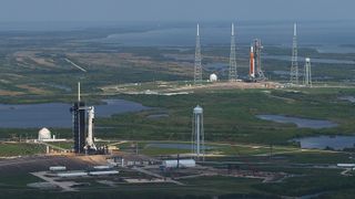 NASA's Space Launch System lunar rocket (right) and a SpaceX Falcon 9 readying for their historic missions at NASA's Kennedy Space Center in Florida in April 2022.