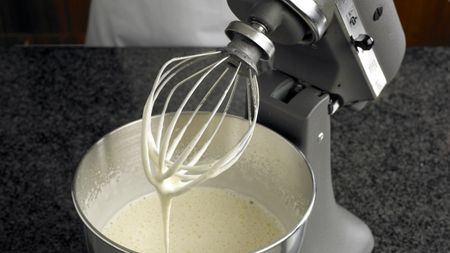 KitchenAid stand mixer being used to mix batter