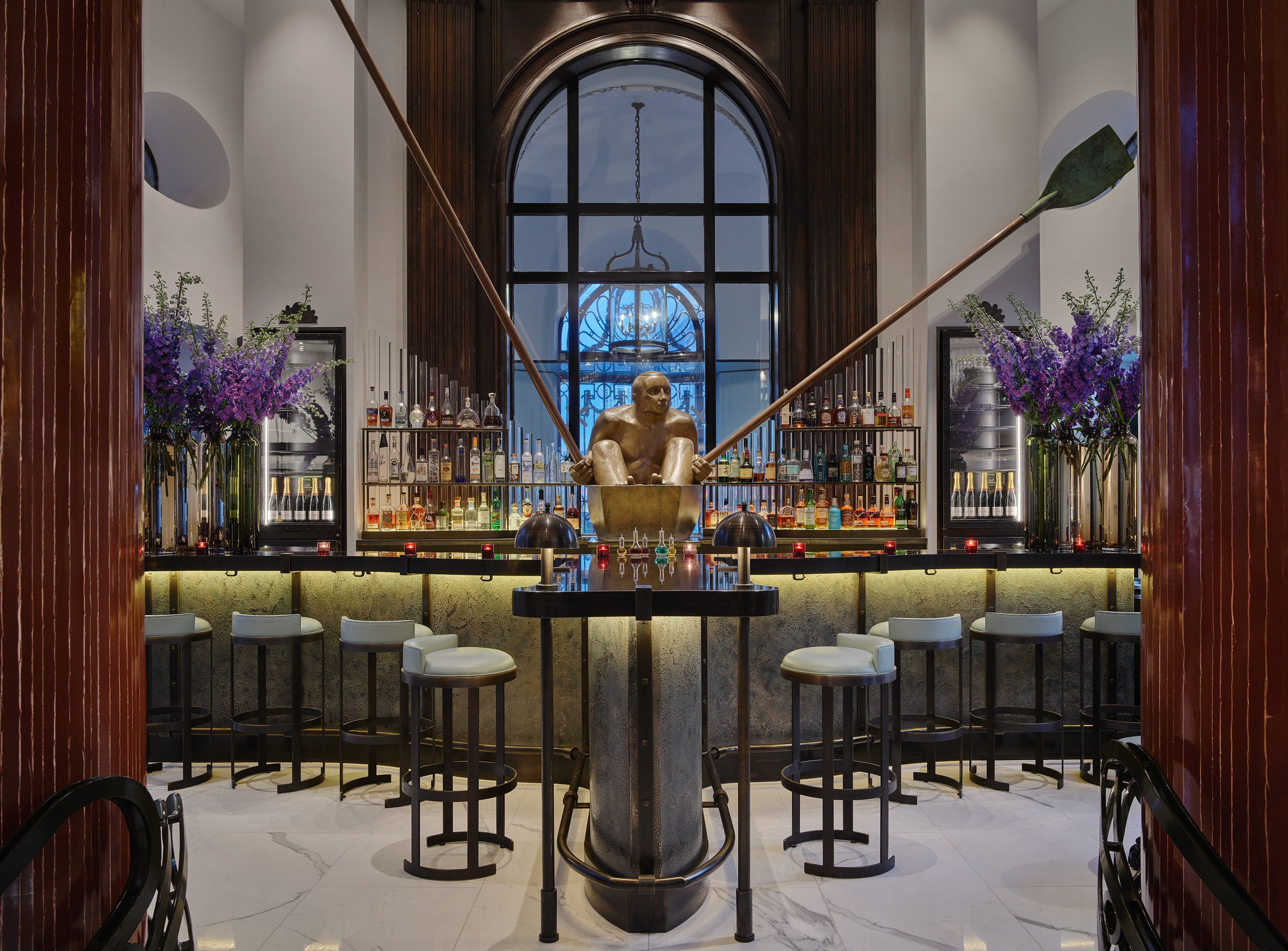 The Lobby Bar at One Aldwych with a large gold sculpture of a man in front of the bar