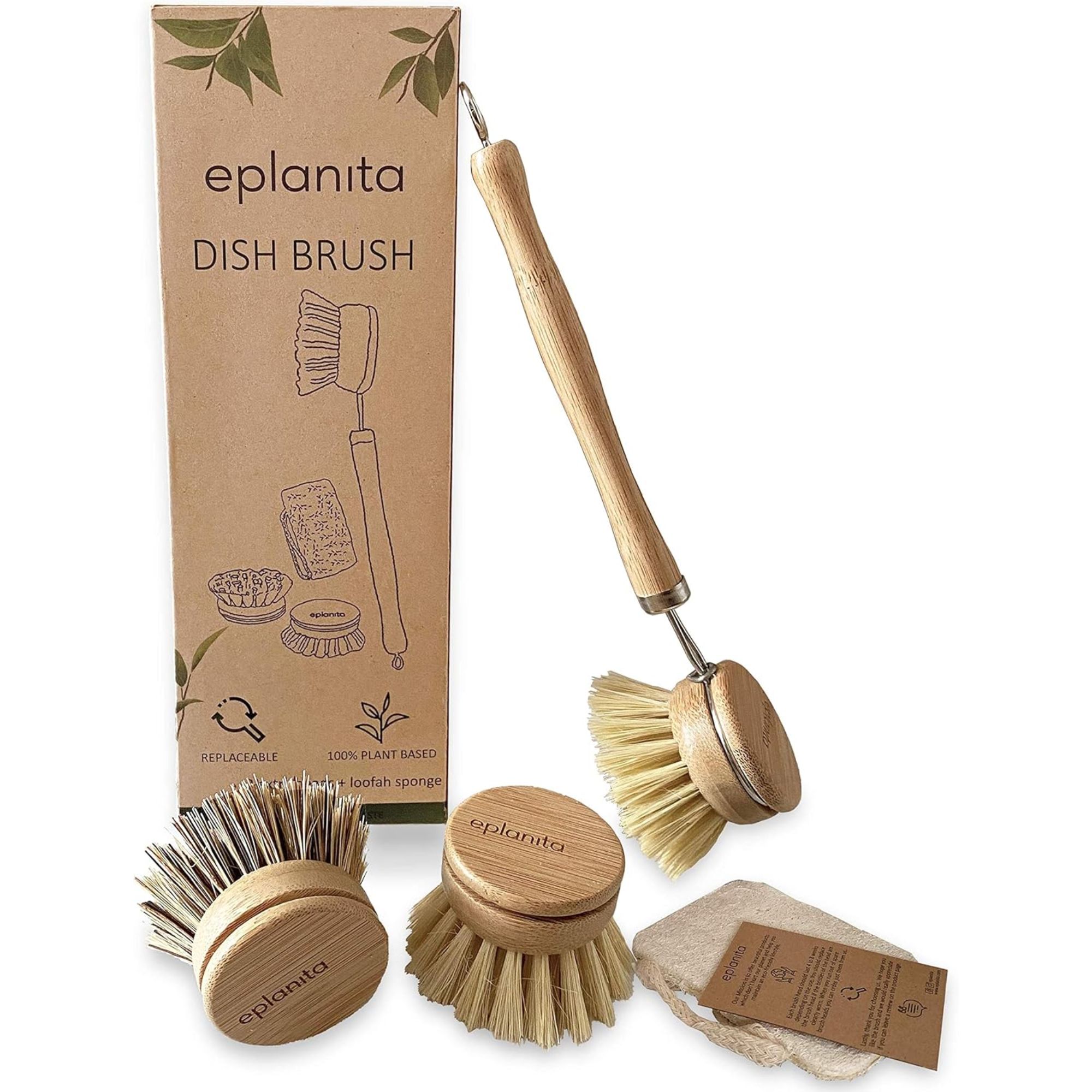 A wooden handled bamboo dish brush leaning against a brown cardboard packaging box with two spare wooden heads