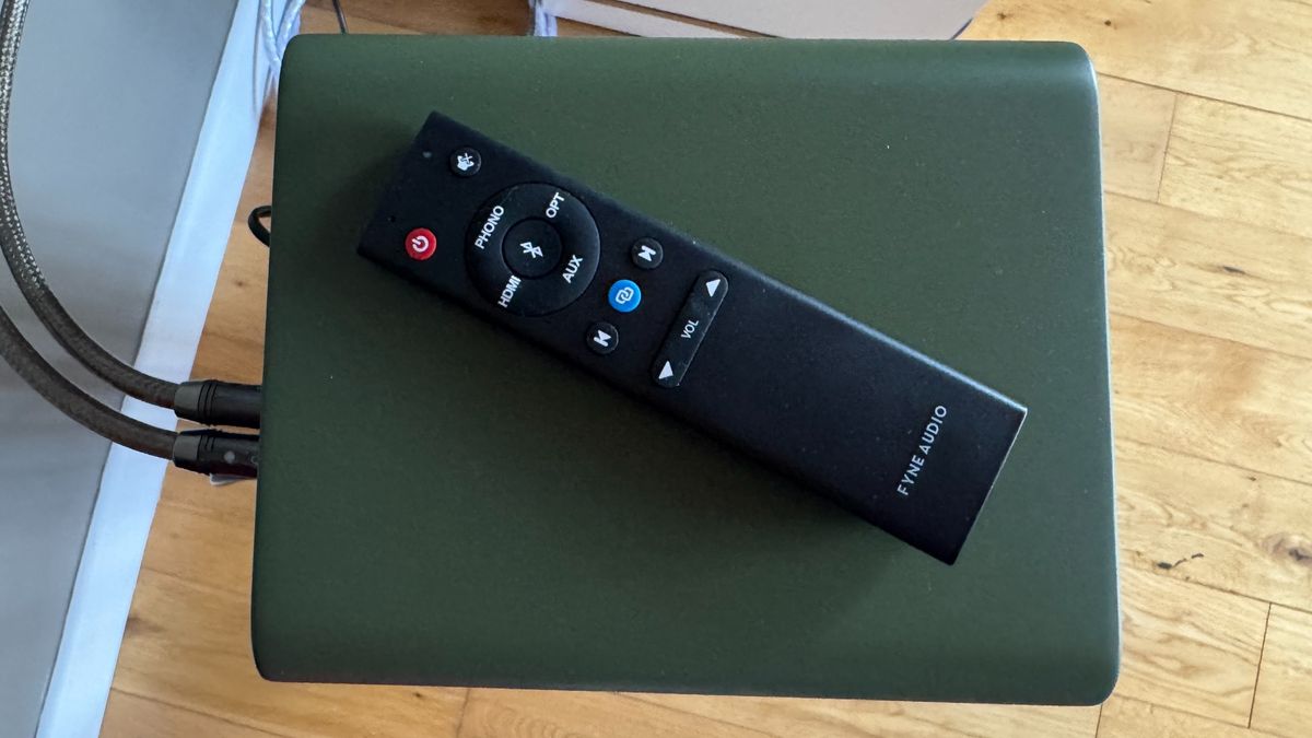 Close-up of the Fyne Audio Cubitt 5 remote control, on a green laptop.