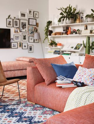 Living room with orange sofa by John Lewis