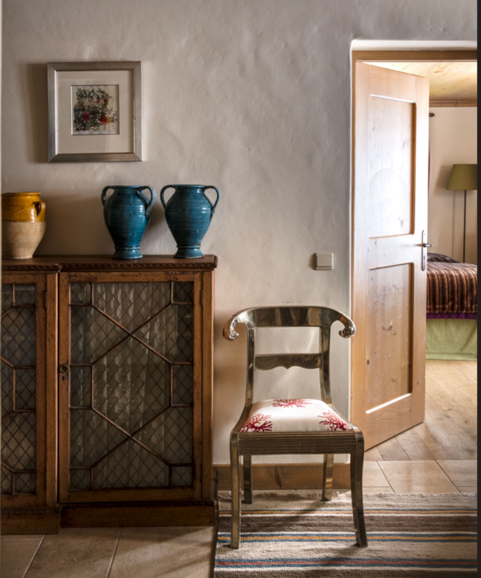 Wooden cabinet with urns and chair