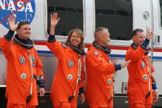 Mission specialists Rex Walheim and Sandy Magnus, shuttle pilot Doug Hurley, and shuttle commander Christopher Ferguson (from left to right) wave to the crowd.