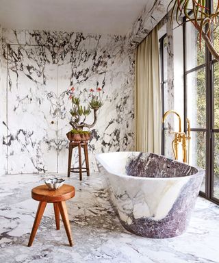 marble bathroom with marble bath, wall and flooring