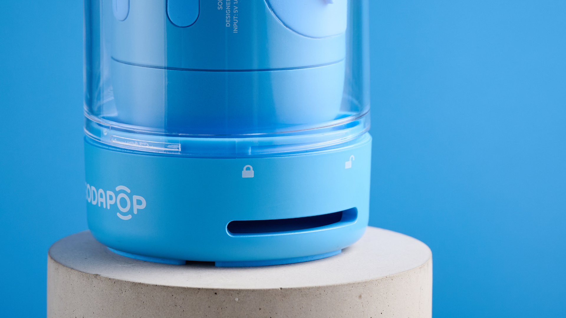 A blue Sodapop Bluetooth speaker that screws onto any regular-sized bottle