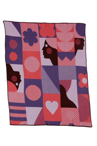 throw blanket in shades of pink, purple, and red with a pattern of geometric shapes and female profiles
