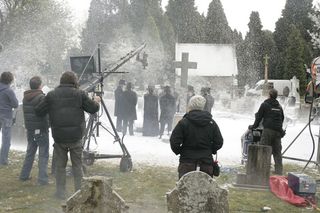 The machines blow fake snow in a burial scene