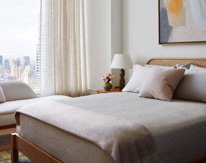 A neutral bedroom with light and airy bed sheets