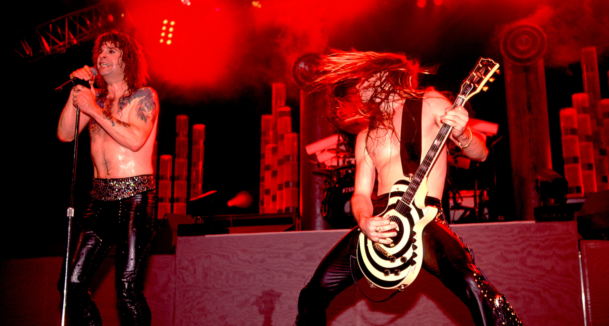 Ozzy Osbourne and Zakk Wylde tear it up onstage in 1989. Ozzy is shirtless. Wylde his shirtless, too – and he plays his bullseye graphic Les Paul.
