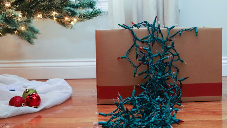 A string of Christmas lights in a box of Christmas decorations