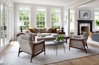 Cozy living room with cream sofa, cream rug and Scandi chairs in fleecy fabric