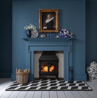 a blue fireplace with patterned tiles