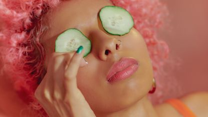 Portrait Of Young Confident Women With Cucumbers On Eyes - stock photo