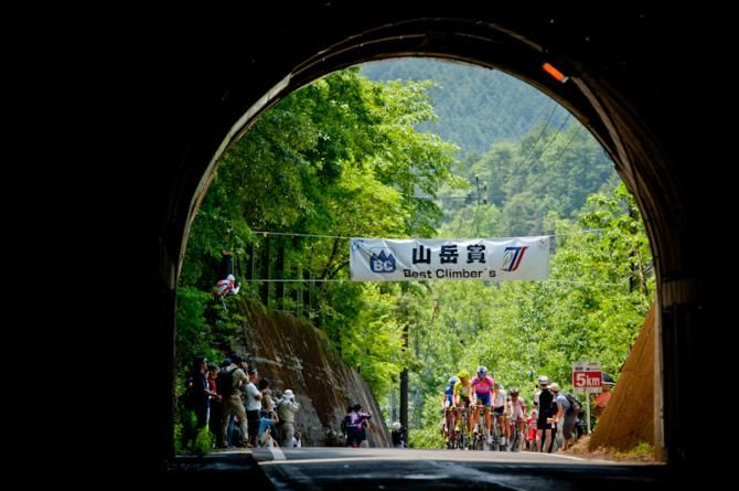 Riders just pass the summit of a mountain at the Tour of Japan on stage 2