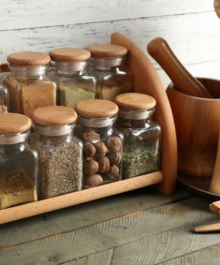 An image of a wooden spice rack organizer with spices on it