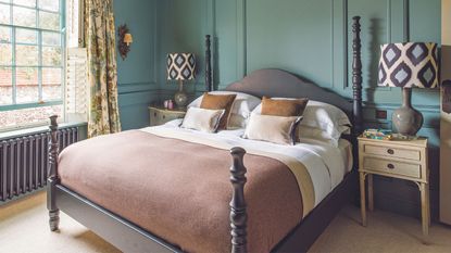 How tall should you bed be? a four poster bed in a teal bedroom