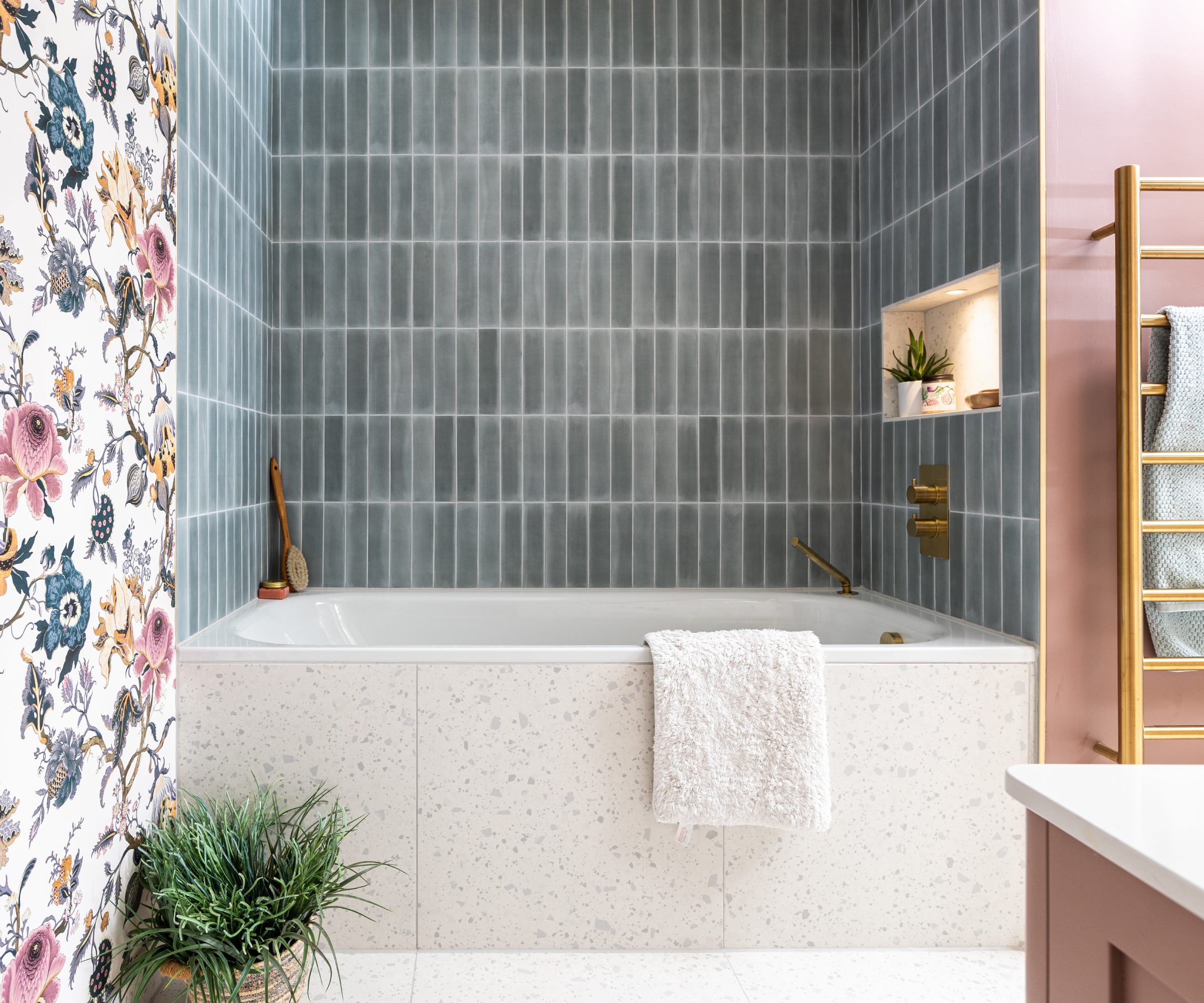 bathroom with pale blue tiles, pink walls and floral wallpaper