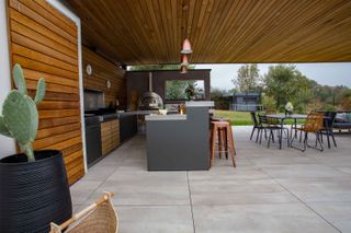 alfa forni pizza oven in outdoor kitchen with concrete pavers