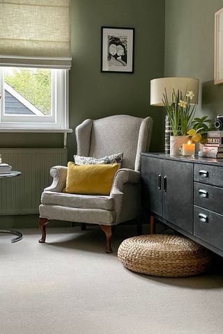 armchair in green living area with side unit