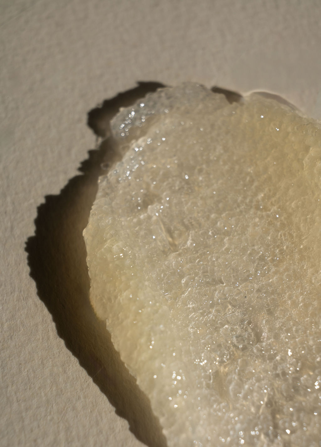 An image of a body scrub against a textured surface.