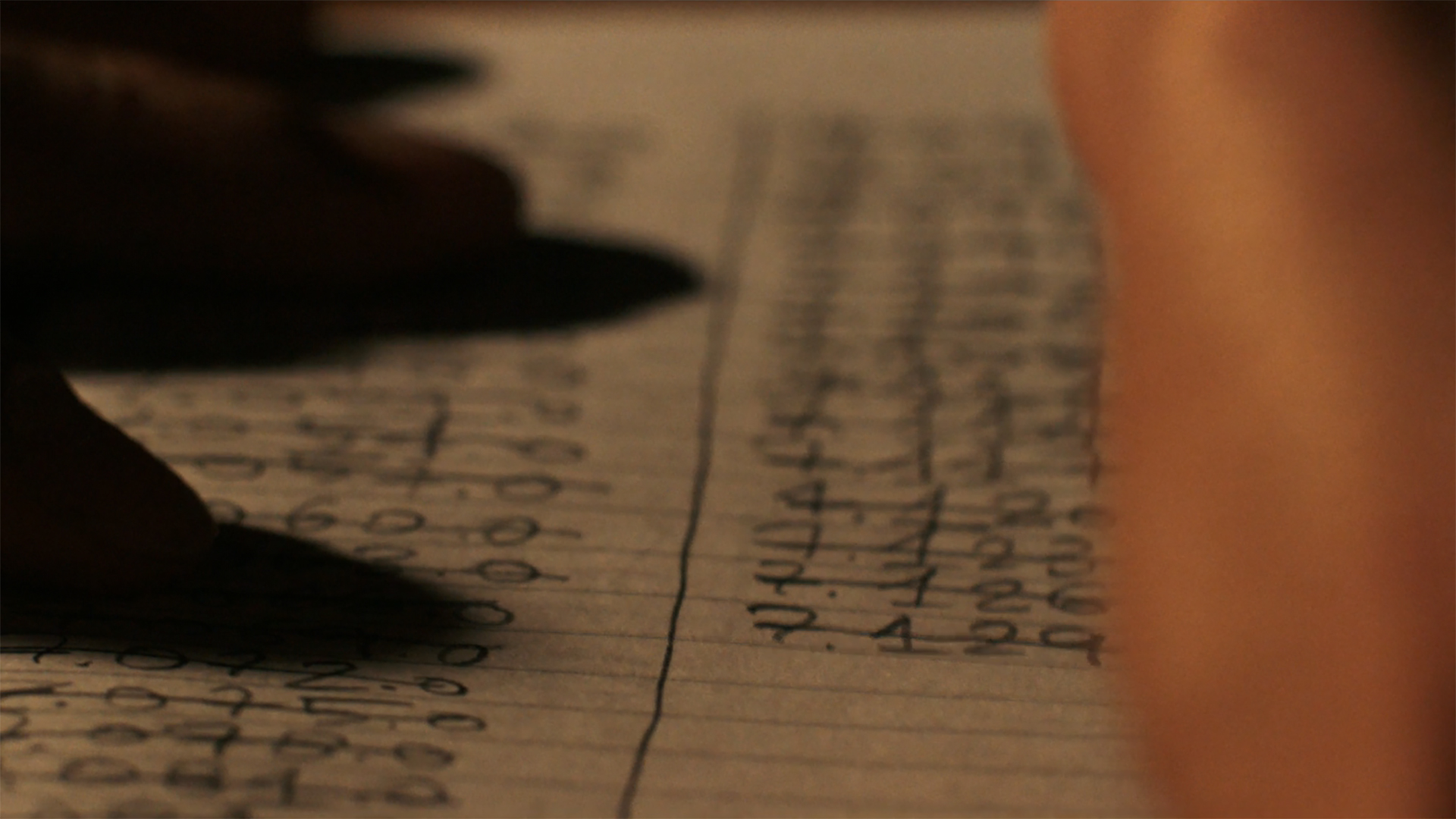 Somebody crossing out radio frequencies on a notepad in Pluribus episode 4