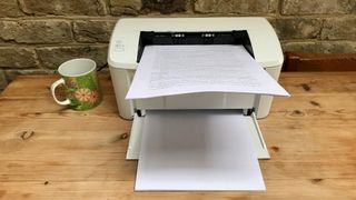 HP LaserJet Pro M15w with paper