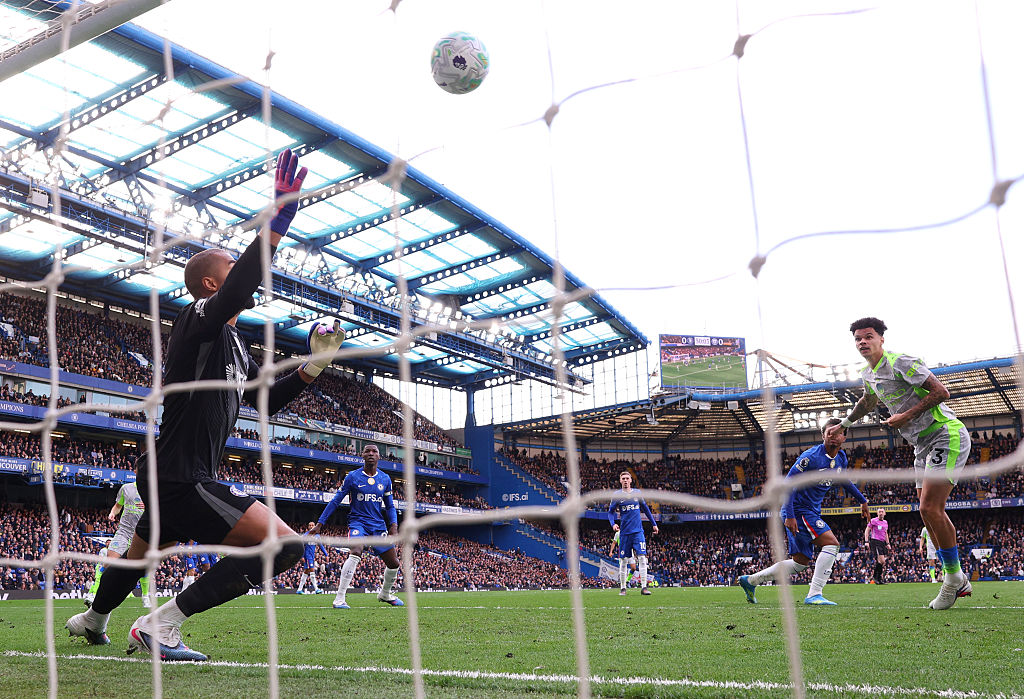 Nico O'Reilly of Manchester City scores his team's first goal past Robert Sanchez of Chelsea