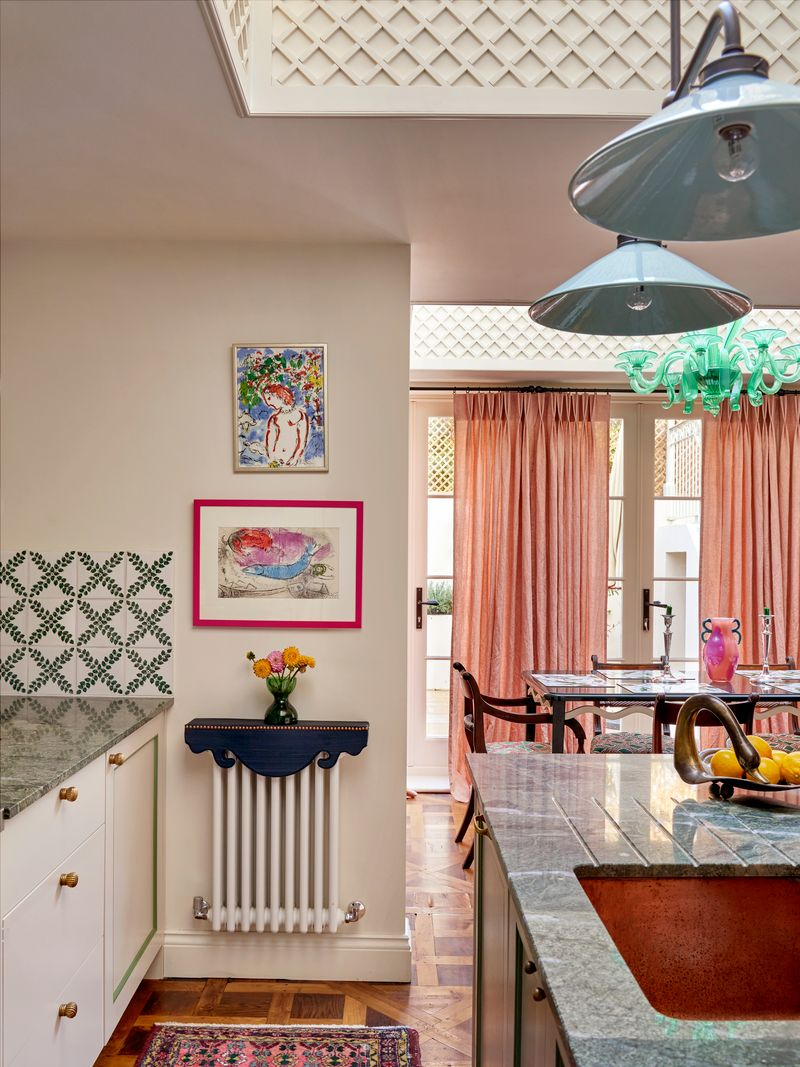 Decorative navy blue raditor cover inside of a playful kitchen