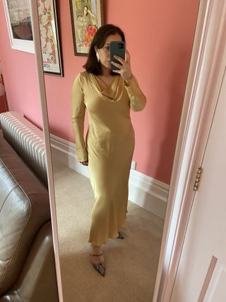 Woman wearing butter yellow Ghost satin bias cut dress