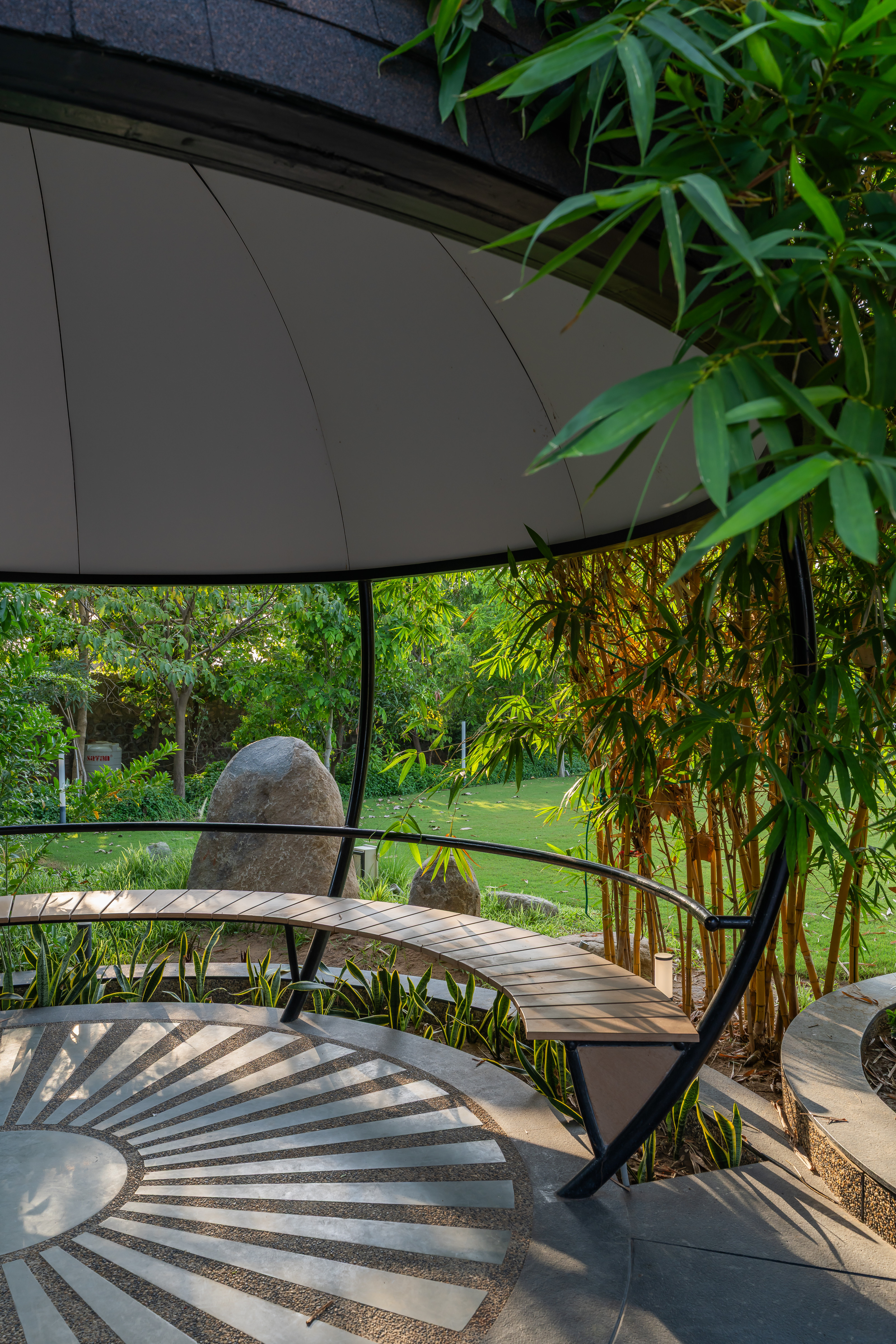 The garden contains a circular gazebo, also designed by the architects