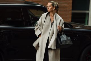 Woman wearing a COS scarf coat.