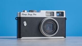 Camp Snap CS-Pro in black and silver photographed on a blue background