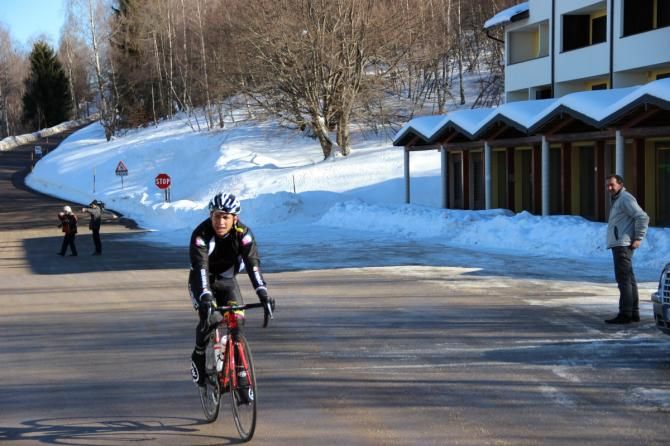 Corti watches his riders arrive at the summit