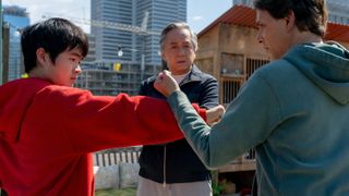 L-R: Li Fong (Ben Wang) training with Mr Han (Jackie Chan) and Daniel LaRusso (Ralph Macchio) in a scene from "Karate Kid: Legends"