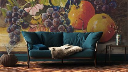 blue sofa against wallpapered wall with large fruit motif