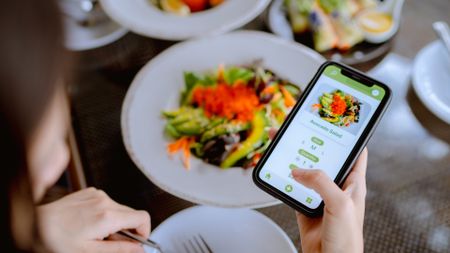 woman tacking an avocado salad on an app