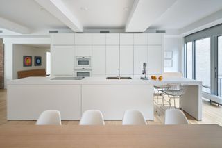 white minimalist kitchen with wood flooring