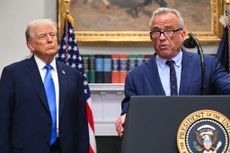 Donald Trump looks on as Robert F. Kennedy Jr. speaks