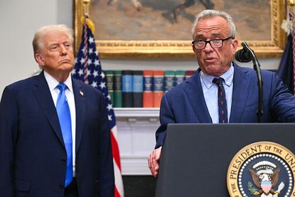 Donald Trump looks on as Robert F. Kennedy Jr. speaks